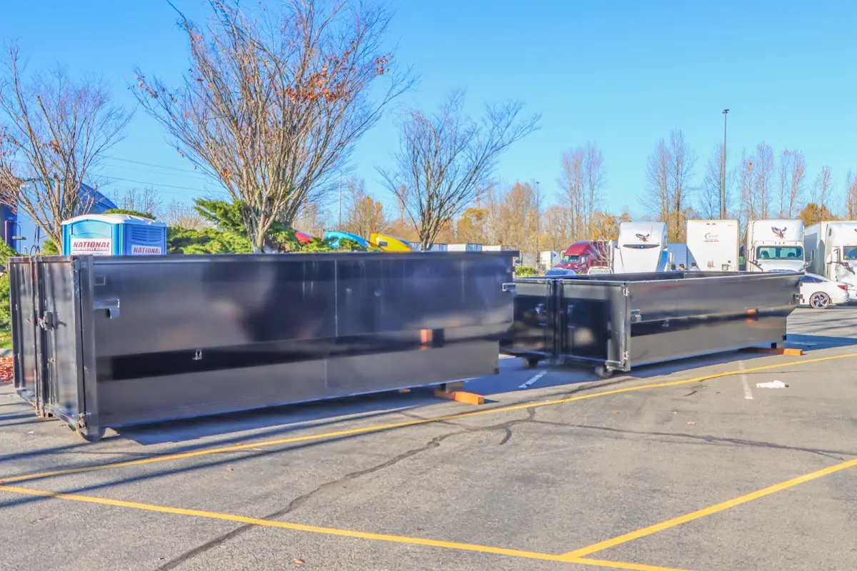 Professional dumpster rental service with roll-off container on residential driveway in Stanwood